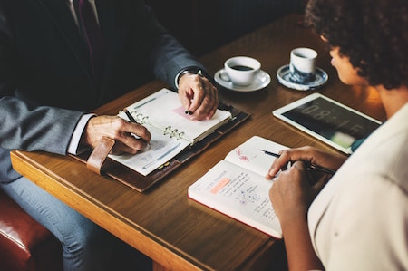 man-woman-table-meeting-planning